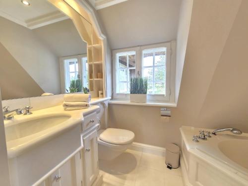 a bathroom with a sink and a toilet and a window at Ferienhaus Cäcilienhof Ost in Kampen