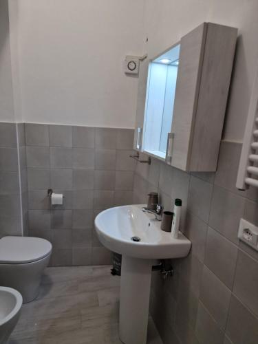 a bathroom with a sink and a toilet and a mirror at Dimore Rosantò in Palombaro