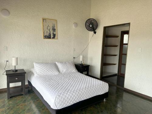 a bedroom with a bed with two night stands and a mirror at Hotel Chalet La Sofia by Majuva in Armenia