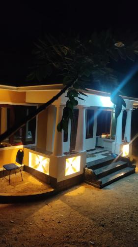a house at night with a chair and lights at Alpine aura in Vagamon