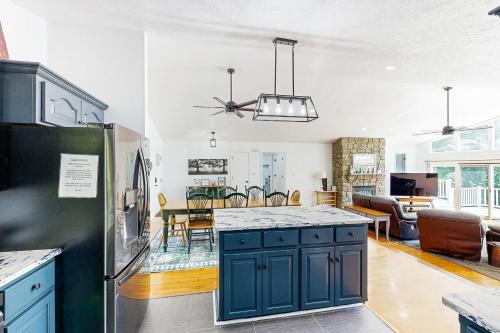 a kitchen and living room with a blue island in a kitchen at Plum Paradise in Glenora