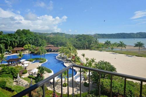 a view of a resort with a pool and a beach at Near Marina Luxury Condo with Pool, Gym, Gold and more in Herradura