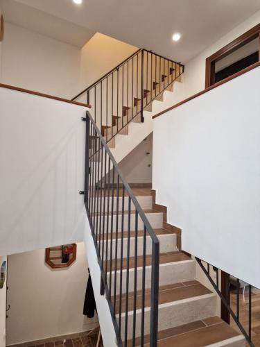 a staircase in a house with white walls and wooden floors at Dimore Rosantò in Palombaro
