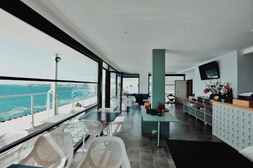 a living room with a view of the ocean at Grand Mirage in Vlorë