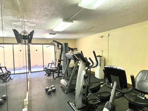a gym with treadmills and exercise bikes in a room at Quality Inn Conference Center Logansport in Logansport