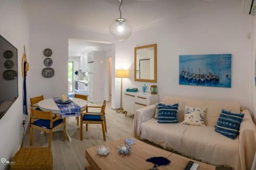 a living room with a couch and a table at Blue Ocean Luxury House in Nea Makri