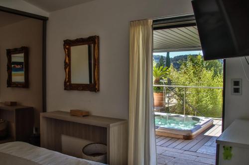 a bedroom with a window with a view of a patio at Villa d'exception au Beausset avec piscine chauffée in Le Beausset