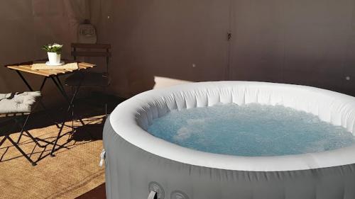 a large bath tub with blue water in a room at LA CASA 44, con Spa opcional in Sariego