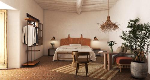 a bedroom with a bed and a table and chairs at Casa Clara by Ananay Hotels in Cusco