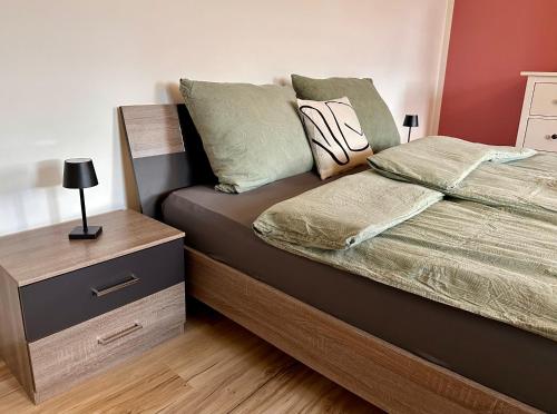 a bedroom with a bed with a nightstand and a bed sidx sidx at Ferienwohnung Storchennest in Eisfeld