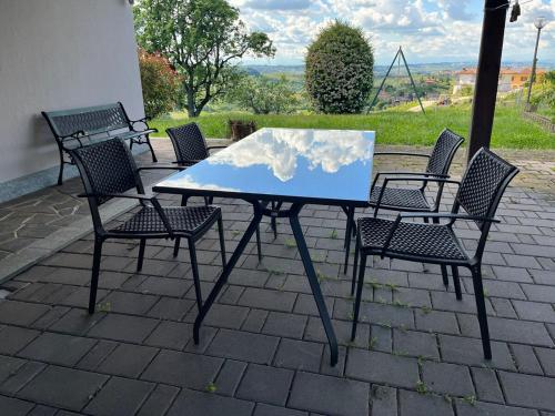 a table with chairs and a table with a map on it at Villa Tra Vigne e Stelle in Neive