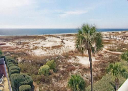 a painting of a desert with a palm tree at Gulf Shores Plantation Condos in Gulf Shores