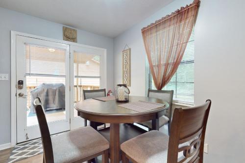 a dining room with a table and chairs and a window at Sequoyah Hideaway in Andersonville