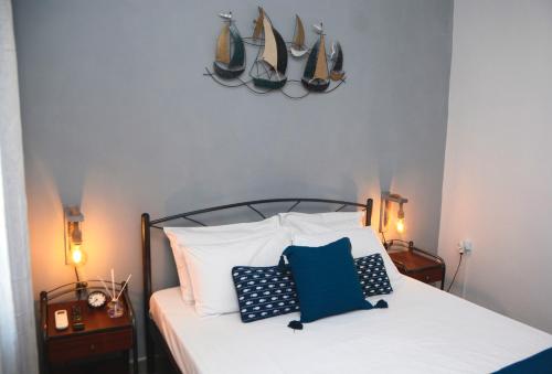 a bedroom with a bed with blue and white pillows at Batsi Bay Premium in Batsi
