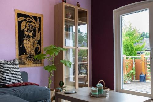 a living room with a blue couch and a window at farbenfrohe Ferienwohnung in Detmold