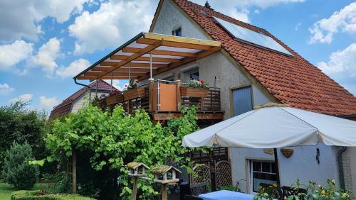 a house with an umbrella in front of it at farbenfrohe Ferienwohnung in Detmold
