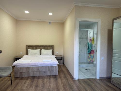 a bedroom with a bed and a walk in shower at Spitak tun in Ijevan