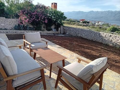 a couple of chairs and a table on a patio at TINAME in Ražanac