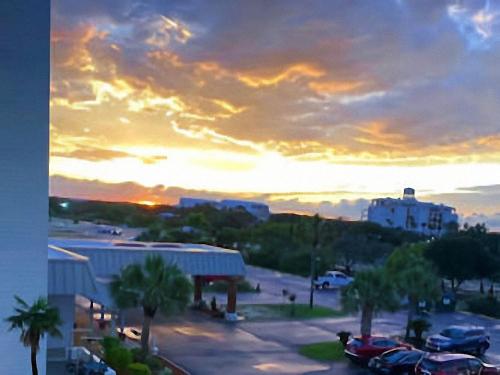 a sunset with cars parked in a parking lot at Gulf Shores Plantation Condos in Gulf Shores