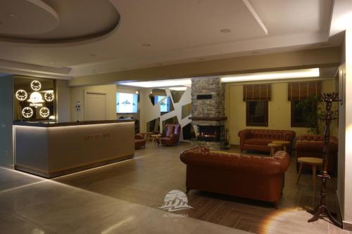 a living room with leather furniture and a fireplace at Ayder Altıparmak Suit in Ayder Yaylasi
