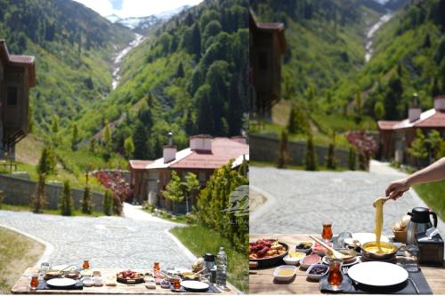 a table with food on it with a view of a mountain at Ayder Altıparmak Suit in Ayder Yaylasi
