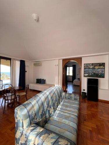 a living room with a couch and a table at Hotel La Piazzetta in Castellammare del Golfo