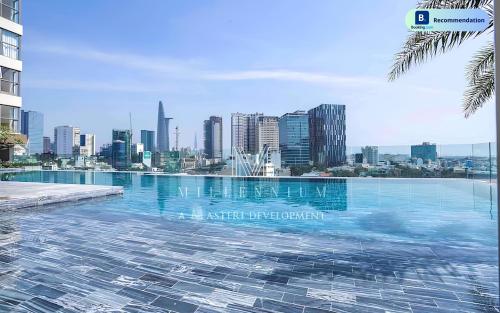 a swimming pool with a city skyline in the background at Blissful Apartment - Masteri Millennium - FREE Infinity Pool in Ho Chi Minh City