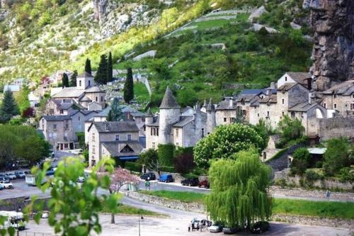 a village on a hill with a mountain at Gîte de la Bergère in La Malène