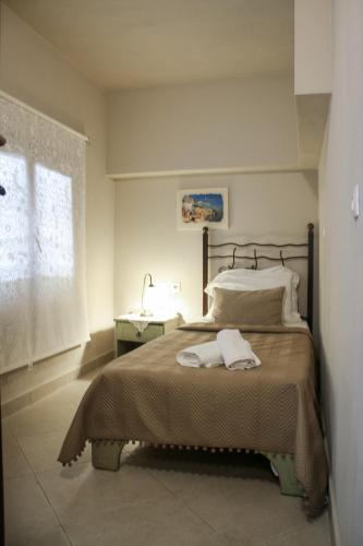a bedroom with a bed with two towels on it at Studios Liotrivi Ouranoupolis in Ouranoupoli
