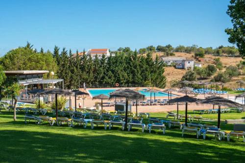 a group of chairs and umbrellas next to a pool at Marina Park 202 in Lagos