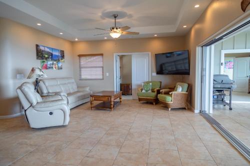 a living room with a couch and chairs and a tv at Kailua-Kona Exceptional Oceanview Home - Heated Oasis Pool & Stunning Ocean View in Kailua-Kona
