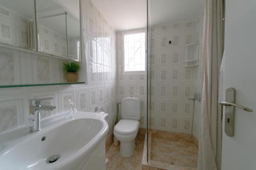 a bathroom with a sink and a toilet and a shower at Selene house in Selínia