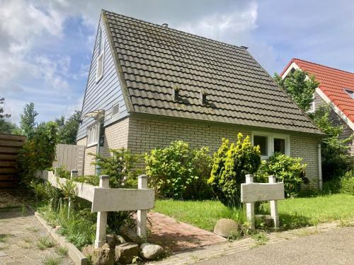 a house with two tombstones in front of it at Holiday house Viktoria at lake Lauwersmeer in Anjum