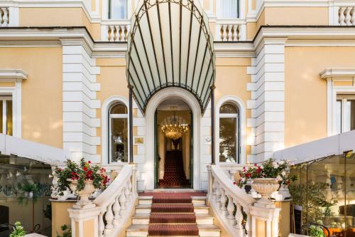 a staircase leading up to a building with flowers at Ena Hotel in Arenzano