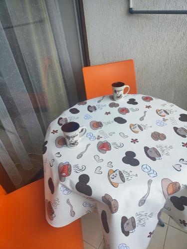 a table with two cups on top of it at Jacky's Apartament - Апартамент в Свети Влас in Sveti Vlas