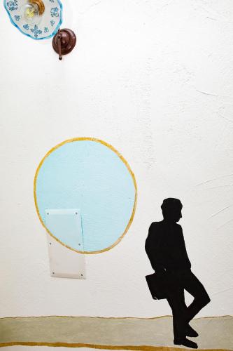 a drawing of a man on a wall with a mirror at La Casa del Corso in Orgosolo