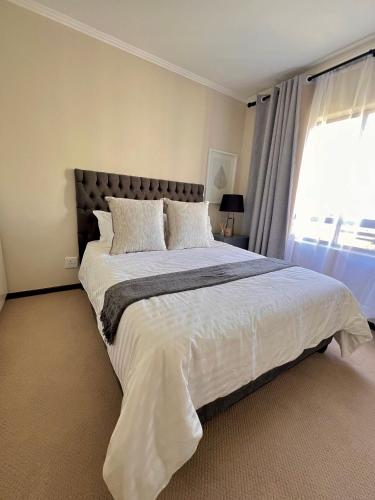 Ένα ή περισσότερα κρεβάτια σε δωμάτιο στο Your Home Away From Home