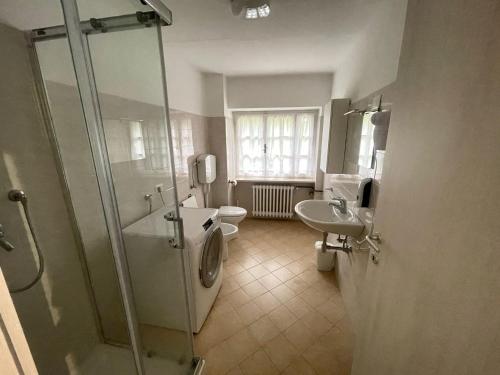a bathroom with a shower and a sink and a toilet at Villa Vittoria in Stresa