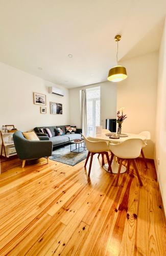 a living room with a table and a couch at 1118 Lofts in Porto