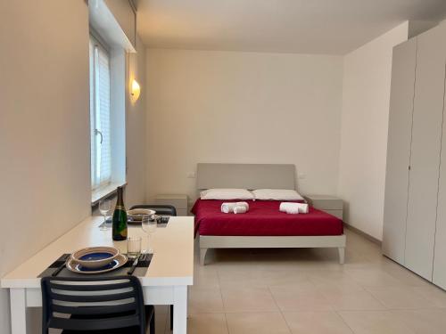 a bedroom with a red bed and a table and chairs at Valpolicella Veneto1 in Negrar