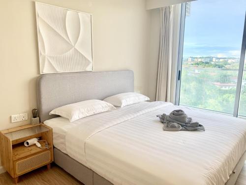 a bedroom with a bed with a large window at Deco Home @ Aru Suites in Kota Kinabalu