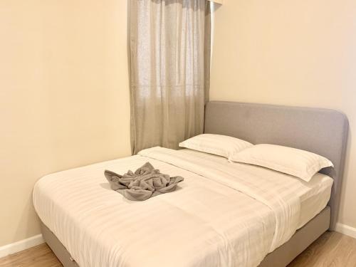 a white bed with a bowl on top of it at Deco Home @ Aru Suites in Kota Kinabalu