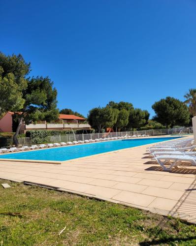 - une piscine dans un complexe avec un ciel bleu clair dans l'établissement Appartement de la Côte bleue, à Martigues