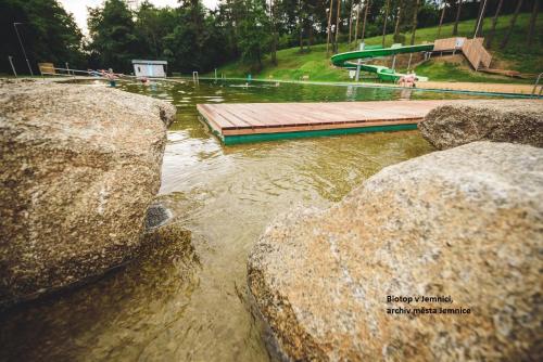 a pool of water with two large rocks at Chalupa Na Polní in Jemnice