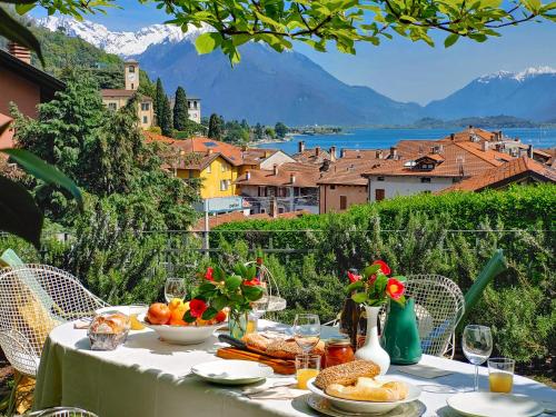 a table with food and a view of a city at Pianoforte in Gravedona