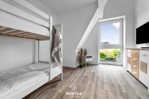 Postel nebo postele na pokoji v ubytování Ferienhaus Sonnenstein Fehmarn