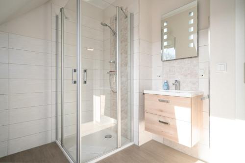 a bathroom with a shower and a sink at Strandhaus 3 OG in Marienfelde