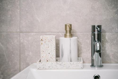 a bathroom sink with a soap dispenser on it at The Rooftop of Apartments Lungo Mare in Ulcinj