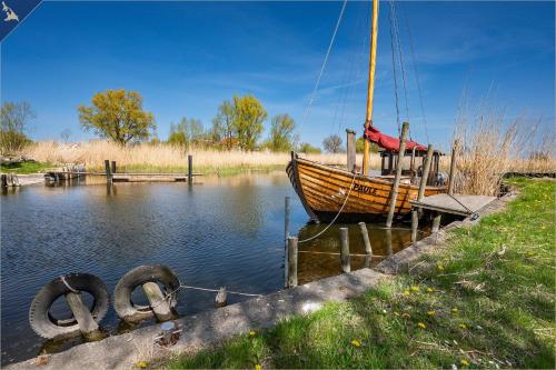 a boat is docked at a dock in the water at Kimpi 3 in Ostseebad Koserow