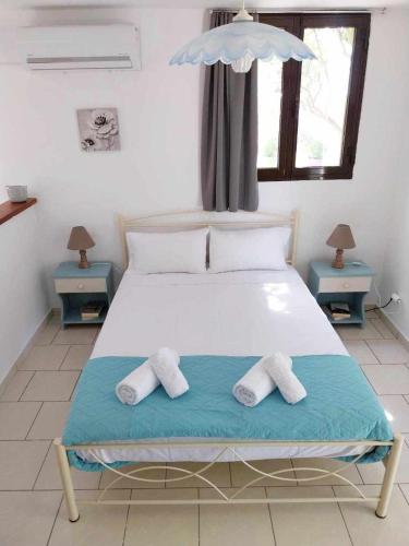 a bedroom with a bed with two towels on it at Daphnes Apartments in Ratzaklíon